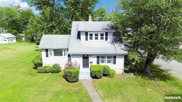 99 Comly Rd, Lincoln Park Borough, NJ 07035 - view of front facade with a front lawn, a chimney, and a shingled roof