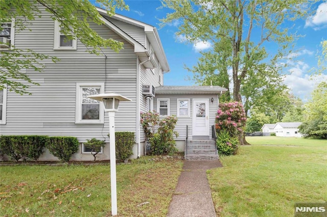 99 Comly Rd, Lincoln Park Borough, NJ 07035 - view of side of home featuring a lawn and entry steps