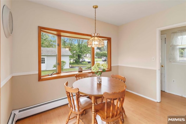 99 Comly Rd, Lincoln Park Borough, NJ 07035 - dining space featuring light wood-style flooring and a baseboard radiator