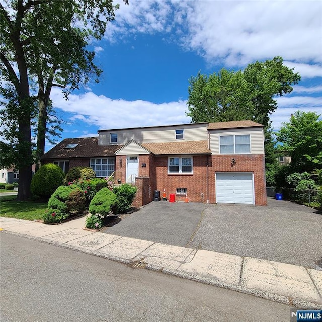 792 Kingsland Ave, Ridgefield, NJ 07657 - view of front facade featuring brick siding, a garage, and asphalt driveway