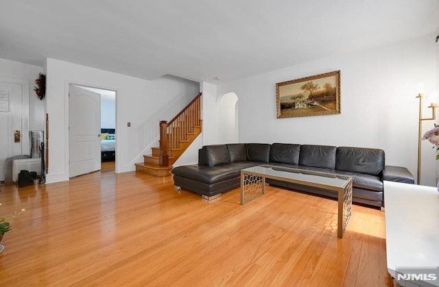 497 Oakdene Ave, Ridgefield, NJ 07657 - living area featuring light wood-style flooring, stairway, and arched walkways