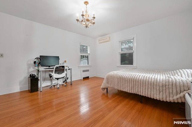 497 Oakdene Ave, Ridgefield, NJ 07657 - bedroom with radiator, a wall mounted air conditioner, a chandelier, light wood-style floors, and baseboards