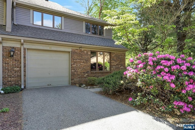 65 Cummings Ct, Mahwah, NJ 07430 - view of front of home with brick siding, asphalt driveway, a garage, and roof with shingles