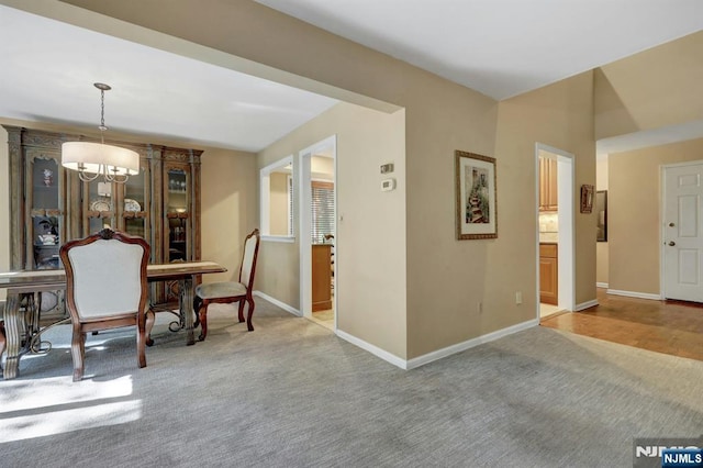 65 Cummings Ct, Mahwah, NJ 07430 - carpeted dining space with baseboards and a chandelier