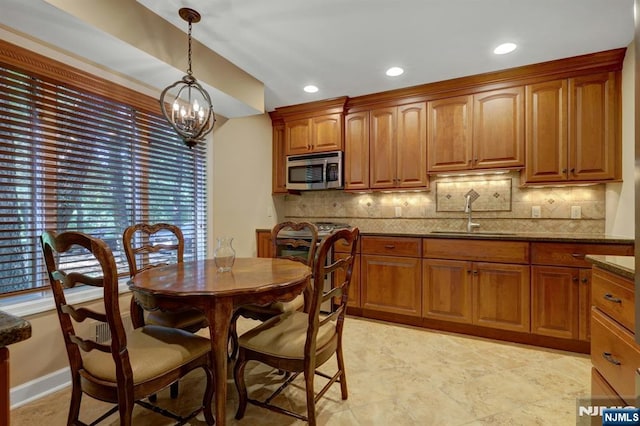 65 Cummings Ct, Mahwah, NJ 07430 - kitchen featuring stainless steel appliances, a sink, tasteful backsplash, brown cabinets, and recessed lighting