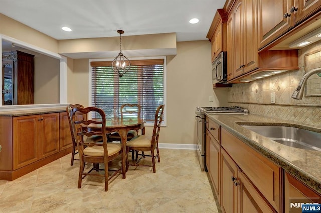 65 Cummings Ct, Mahwah, NJ 07430 - kitchen featuring a sink, stainless steel appliances, brown cabinets, tasteful backsplash, and decorative light fixtures