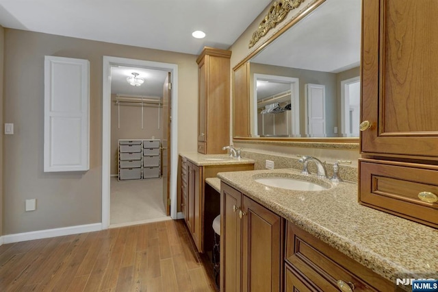 65 Cummings Ct, Mahwah, NJ 07430 - full bath with two vanities, wood finished floors, baseboards, and a walk in closet