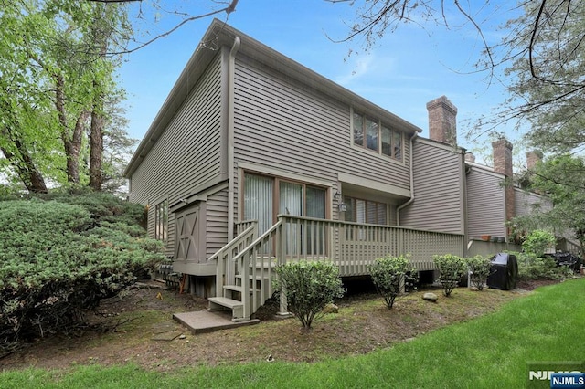 65 Cummings Ct, Mahwah, NJ 07430 - rear view of property with a deck and a chimney