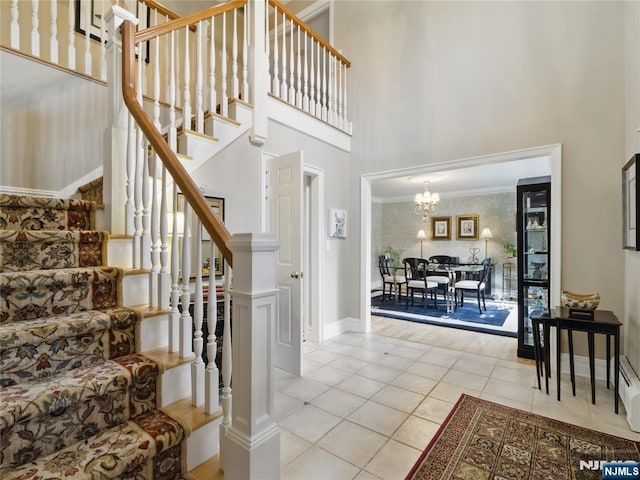 20 Tuxedo Ave, Park Ridge, NJ 07656 - staircase with a towering ceiling, a chandelier, tile patterned floors, baseboards, and crown molding
