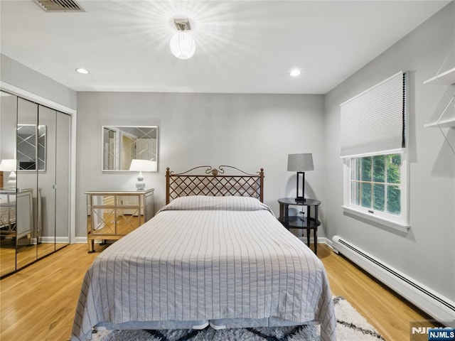 20 Tuxedo Ave, Park Ridge, NJ 07656 - bedroom with baseboard heating, wood finished floors, a closet, recessed lighting, and baseboards