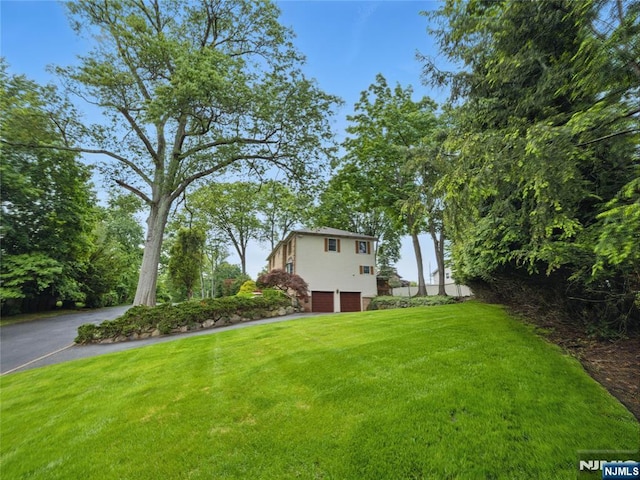 20 Tuxedo Ave, Park Ridge, NJ 07656 - view of grassy yard featuring a garage and driveway