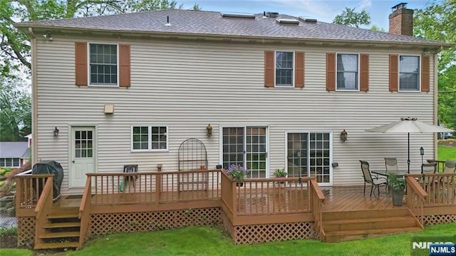 20 Tuxedo Ave, Park Ridge, NJ 07656 - back of property with a chimney, a lawn, a wooden deck, and outdoor dining area