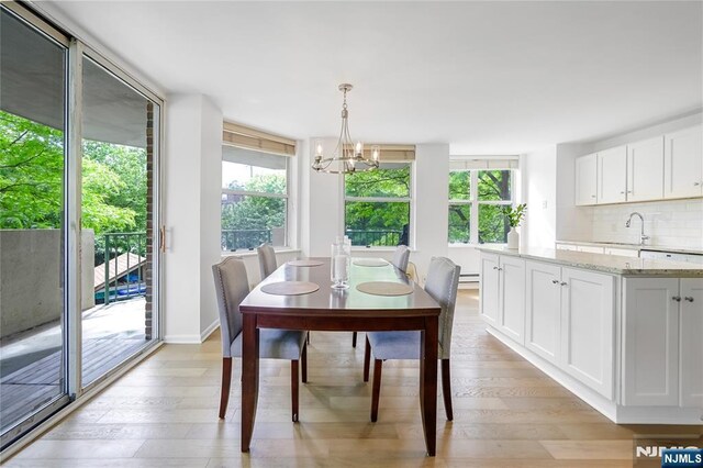 100 Grand Cove Way Unit 2D, Edgewater, NJ 07020 - dining room with a chandelier and light wood finished floors