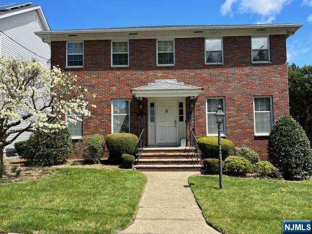 74 Fischer Ave, Nutley, NJ 07110 - view of front of property with a front lawn and brick siding