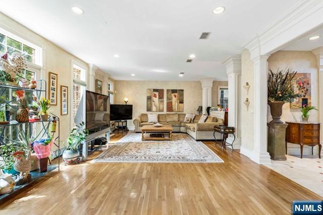 50 Claremont Rd, Fort Lee, NJ 07024 - living area with ornate columns, wood finished floors, recessed lighting, and baseboards