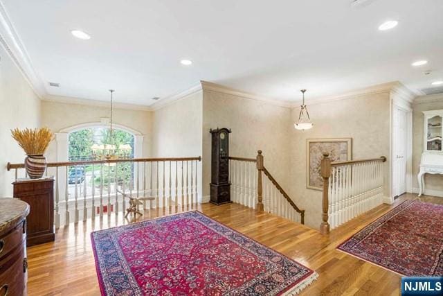 50 Claremont Rd, Fort Lee, NJ 07024 - hallway with an upstairs landing, crown molding, wood finished floors, a chandelier, and recessed lighting