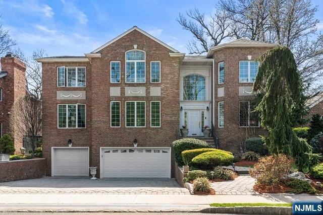 50 Claremont Rd, Fort Lee, NJ 07024 - view of front facade with a garage, concrete driveway, and brick siding