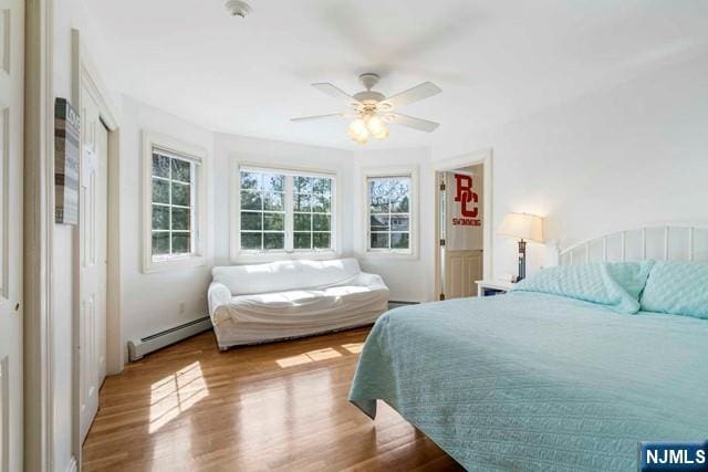 50 Claremont Rd, Fort Lee, NJ 07024 - bedroom featuring a baseboard radiator, wood finished floors, and ceiling fan
