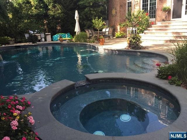 50 Claremont Rd, Fort Lee, NJ 07024 - view of pool with a pool with connected hot tub and a patio area