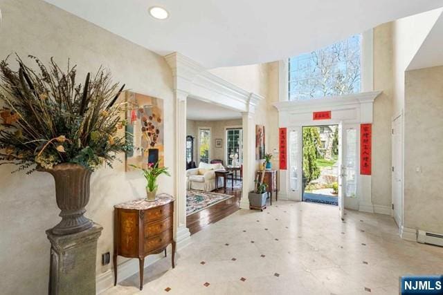 50 Claremont Rd, Fort Lee, NJ 07024 - entrance foyer featuring plenty of natural light, ornate columns, and baseboards