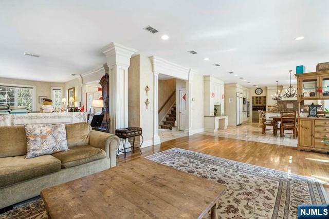 50 Claremont Rd, Fort Lee, NJ 07024 - living area with stairs, light wood-type flooring, recessed lighting, ornate columns, and baseboards