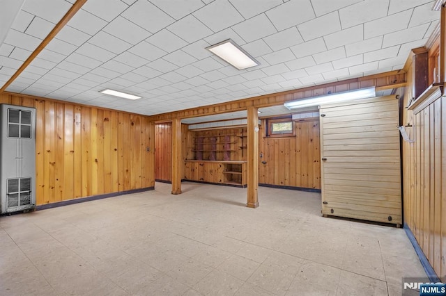 15 Strawberry Hill Rd, Hillsdale, NJ 07642 - below grade area with a heating unit, wooden walls, light flooring, and baseboards