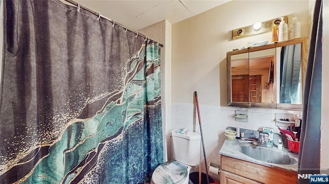 129-131 Seymour Ave, Newark, NJ 07108 - bathroom featuring vanity, toilet, curtained shower, a wainscoted wall, and tile walls