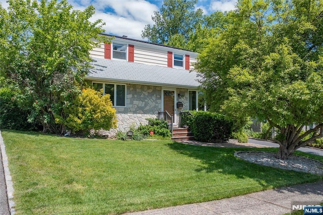 9 Rutan Pl, Bloomfield, NJ 07003 - view of front of home featuring stone siding, a front lawn, and roof with shingles
