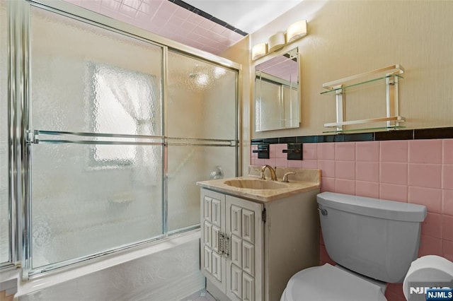 9 Rutan Pl, Bloomfield, NJ 07003 - bathroom featuring toilet, a shower with door, vanity, and tile walls