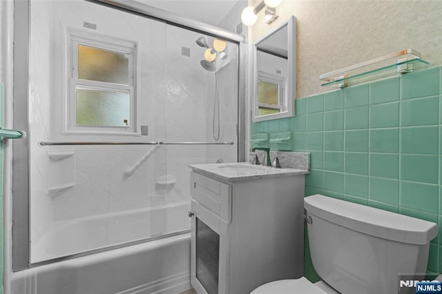 9 Rutan Pl, Bloomfield, NJ 07003 - bathroom with vanity, toilet, and bath / shower combo with glass door