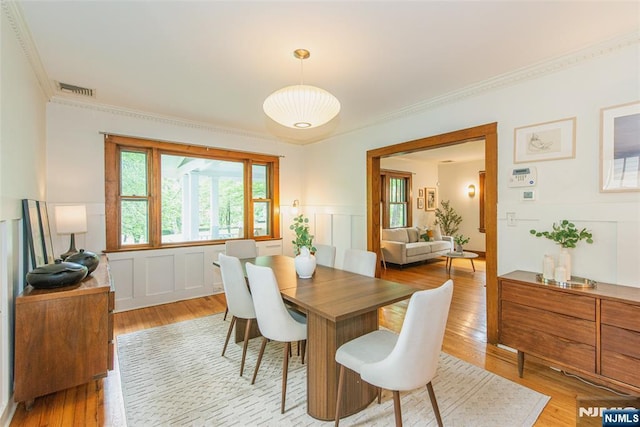 27 Nassau Rd, Montclair, NJ 07043 - dining room with a decorative wall, ornamental molding, light wood finished floors, and wainscoting