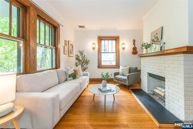 27 Nassau Rd, Montclair, NJ 07043 - living area with wood finished floors, healthy amount of natural light, a fireplace, and crown molding