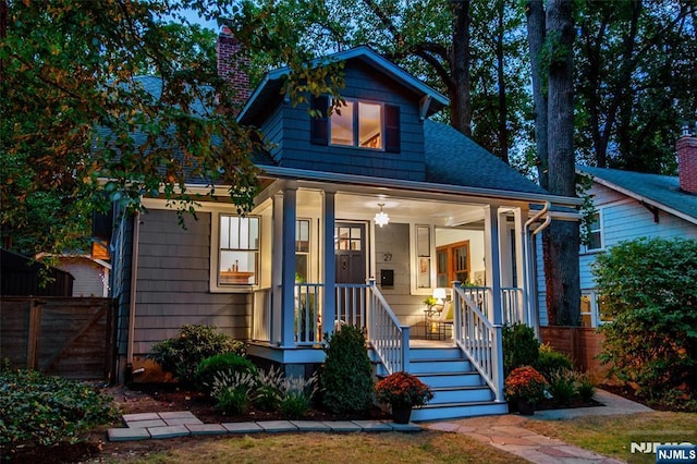 27 Nassau Rd, Montclair, NJ 07043 - view of front facade with a chimney, a porch, and roof with shingles