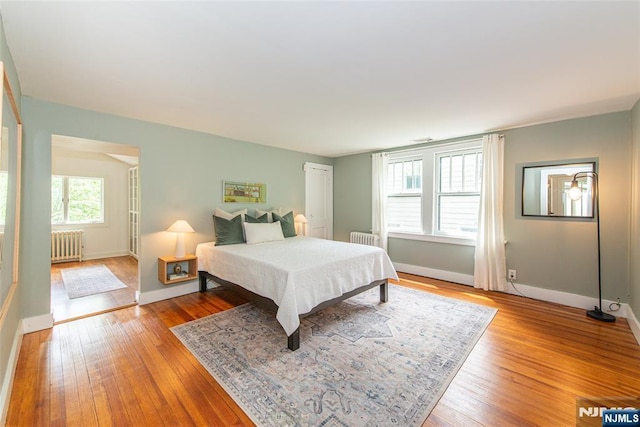 27 Nassau Rd, Montclair, NJ 07043 - bedroom with radiator heating unit, baseboards, and light wood-style flooring