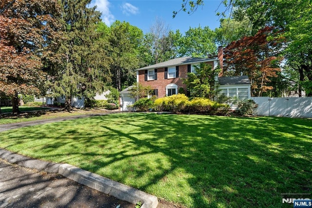 12 Louise Ln, Tenafly, NJ 07670 - view of front of house with a chimney, a garage, and brick siding