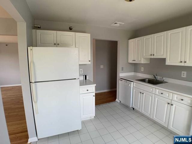 18 Prospect St Unit 4, Palisades Park, NJ 07650 - kitchen with freestanding refrigerator, dishwasher, a sink, light countertops, and white cabinets