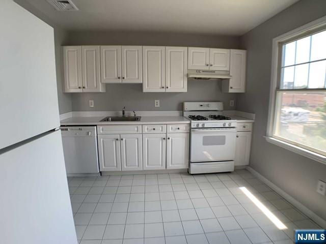 18 Prospect St Unit 4, Palisades Park, NJ 07650 - kitchen featuring white appliances, under cabinet range hood, a sink, light countertops, and white cabinets
