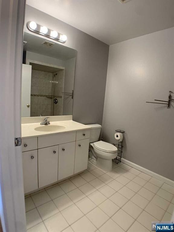 18 Prospect St Unit 4, Palisades Park, NJ 07650 - full bath with vanity, toilet, tile patterned floors, a tile shower, and baseboards