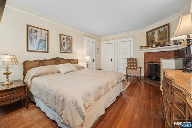 74 Oakdene Ave, Cliffside Park, NJ 07010 - bedroom featuring a closet, dark wood-type flooring, a brick fireplace, and ornamental molding