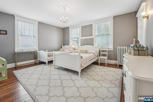 74 Oakdene Ave, Cliffside Park, NJ 07010 - bedroom with radiator heating unit, dark wood finished floors, a chandelier, and multiple windows