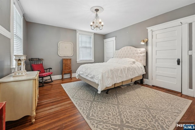 74 Oakdene Ave, Cliffside Park, NJ 07010 - bedroom with a chandelier, baseboards, and dark wood-type flooring