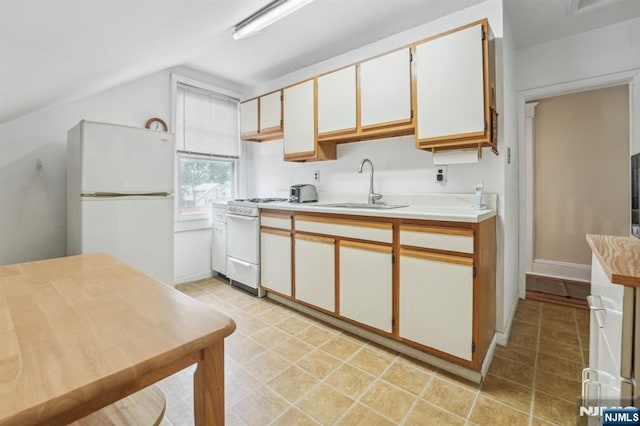 74 Oakdene Ave, Cliffside Park, NJ 07010 - kitchen featuring white appliances, a sink, vaulted ceiling, light countertops, and white cabinetry