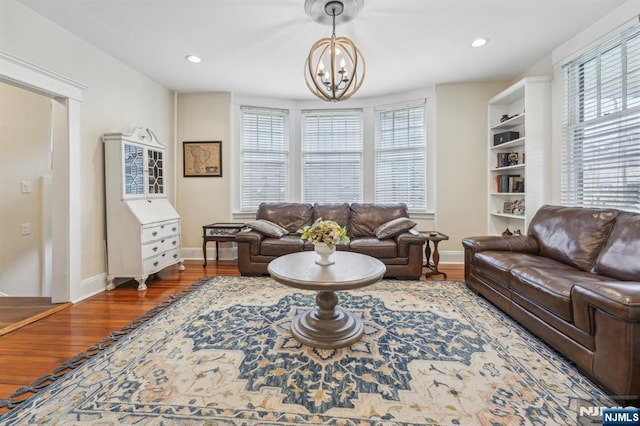 74 Oakdene Ave, Cliffside Park, NJ 07010 - living room with wood finished floors, a chandelier, baseboards, and recessed lighting