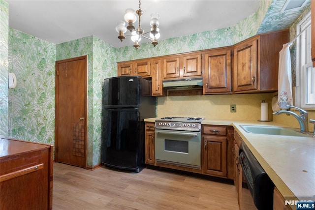3 Gregory Ter, Belleville, NJ 07109 - kitchen with wallpapered walls, black appliances, a sink, brown cabinets, and a chandelier