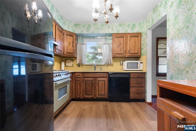 3 Gregory Ter, Belleville, NJ 07109 - kitchen featuring white appliances, a chandelier, wallpapered walls, a sink, and brown cabinetry