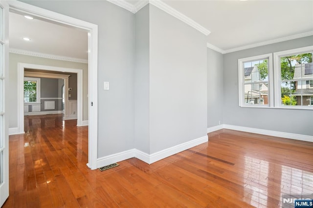 217 Grayson Pl, Teaneck, NJ 07666 - empty room featuring plenty of natural light, crown molding, wood-type flooring, and baseboards