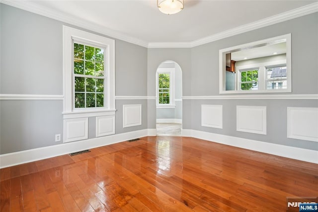 217 Grayson Pl, Teaneck, NJ 07666 - empty room featuring arched walkways, hardwood / wood-style floors, ornamental molding, and baseboards