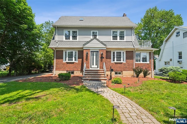 217 Grayson Pl, Teaneck, NJ 07666 - view of front of house with a front yard, brick siding, and a chimney
