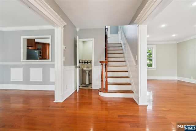 217 Grayson Pl, Teaneck, NJ 07666 - stairway with ornamental molding, wood finished floors, recessed lighting, baseboards, and wainscoting