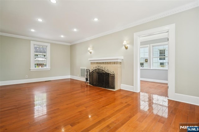 217 Grayson Pl, Teaneck, NJ 07666 - unfurnished living room featuring ornamental molding, a tiled fireplace, recessed lighting, wood finished floors, and baseboards